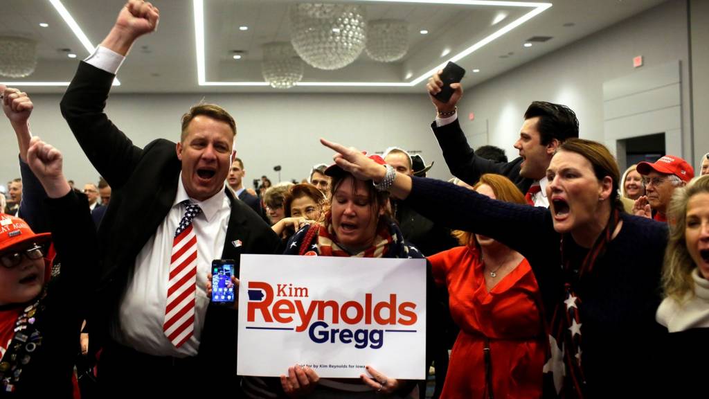 Supporters of Iowa's Republican Governor Kim Keynolds celebrate as he is re-elected