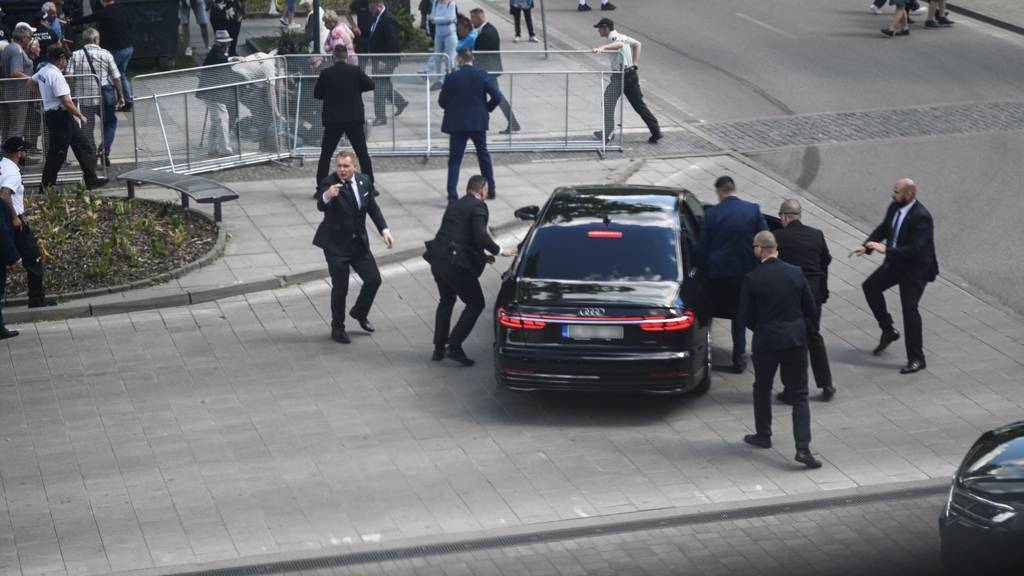 Security officers move Slovak PM Robert Fico in a car after a shooting incident, after a Slovak government meeting in Handlova,