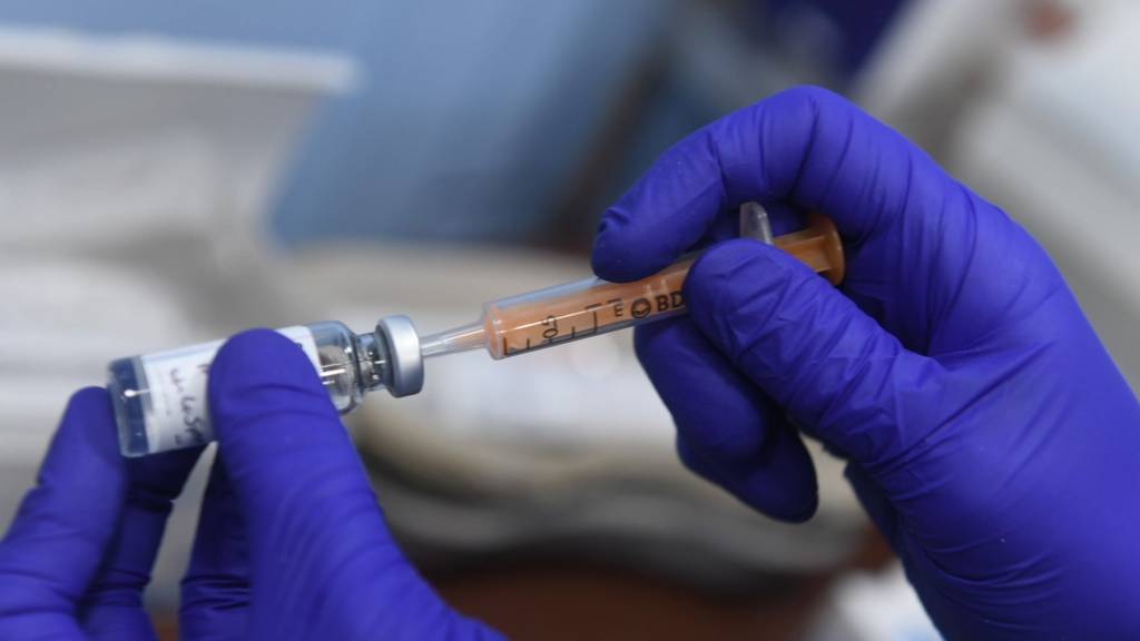 A dose of the Oxford/AstraZeneca coronavirus vaccine is prepared