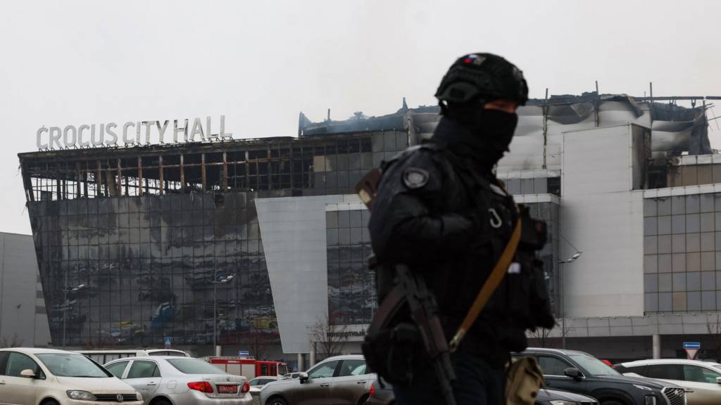 A law enforcement officer patrols the scene of the gun attack at the Crocus City Hall concert hall in Krasnogorsk, outside Moscow, on March 23, 2024.