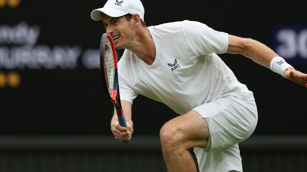Andy Murray crouches to play a slice