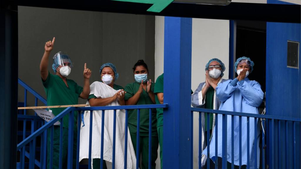 Medical staff cheer at a hospital in El Salvador
