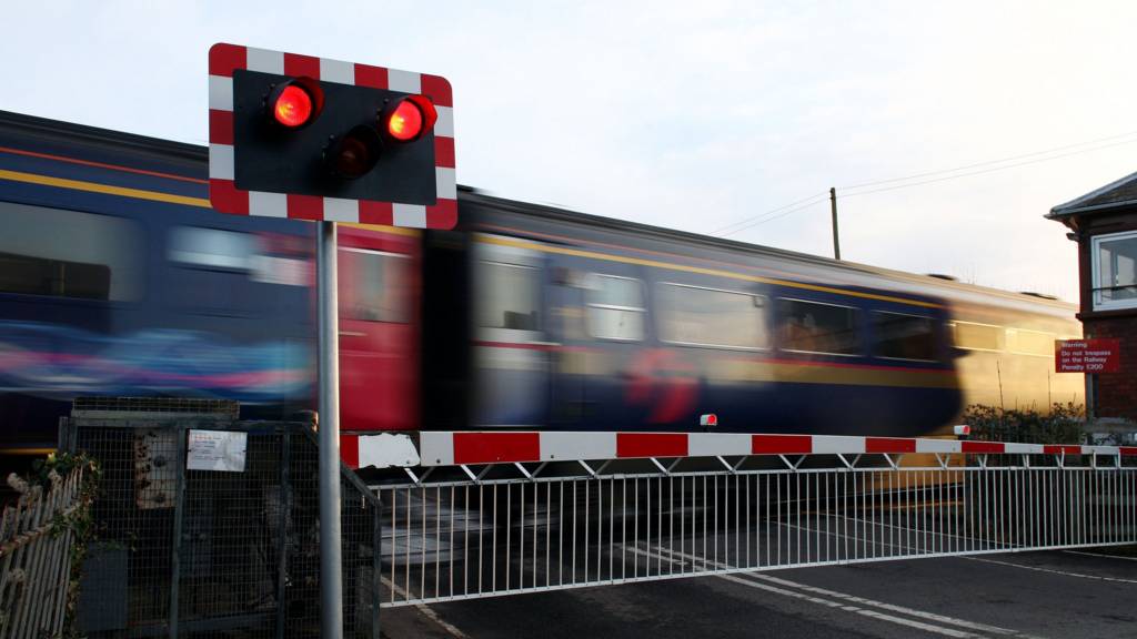Train goes through level crossing