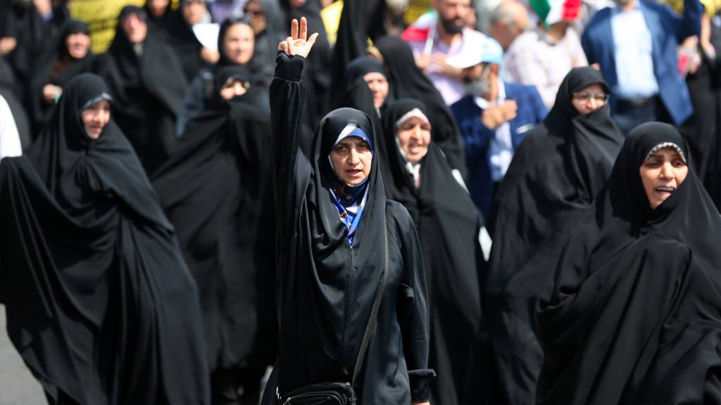 People march with flags and banners to celebrate Iran's 13 April attack on Israel and protest Israel, which is accused of carrying out the attack that caused explosions in Isfahan and Tabriz on 19 April 2024 in Tehran, Iran