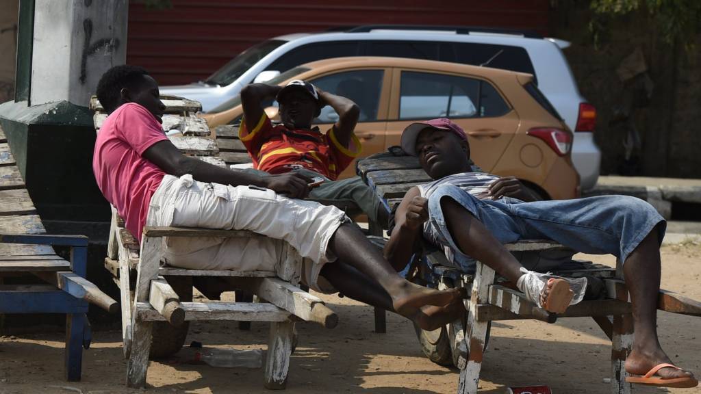 men relax in Luanda