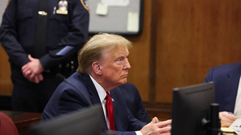 Donald Trump sits in court