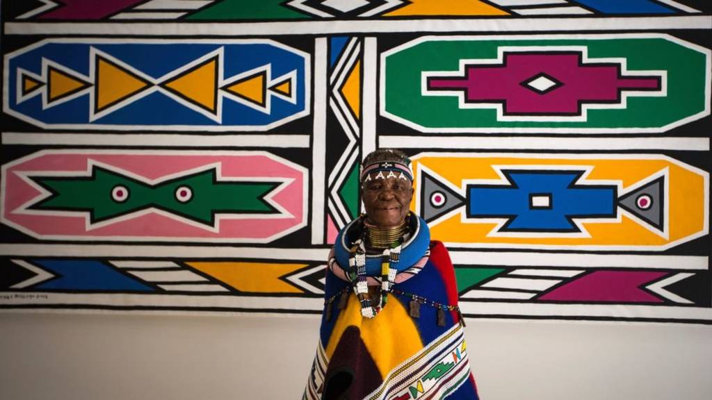 South African artist Esther Mahlangu, 81, poses in front of her artwork on March 1, 2017 at the Melrose Gallery in Johannesburg.