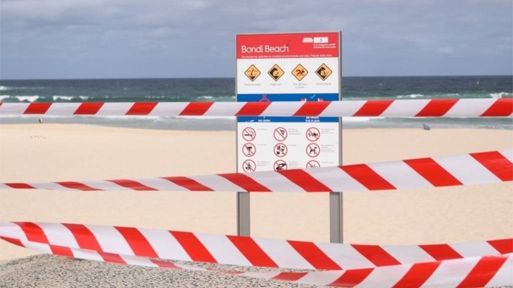 Tape is across an entrance to Bondi Beach following its closure to the public by authorities, in Sydney, Australia, 21 March 2020.