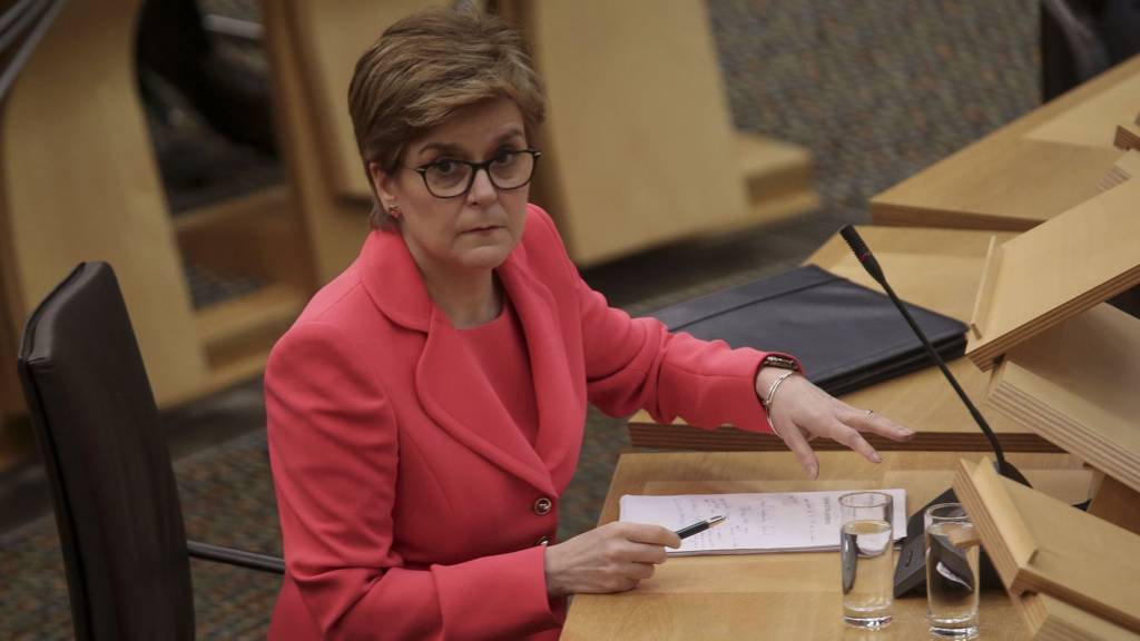 Scottish First Minister Nicola Sturgeon reacts as she attends the Scottish Parliament to give updates to MSPs on any changes to the Covid restrictions