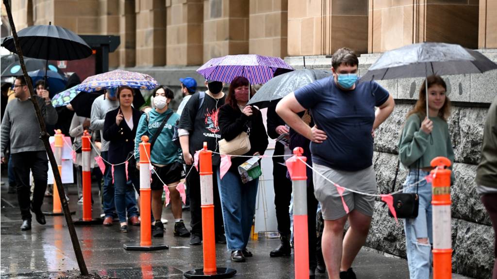 Voters queue outside a polling booth on May 21, 2022 in Brisbane, Australia. Australians head to the polls today to elect the 47th Parliament of Australia, with a tight battle between incumbent Prime Minister Scott Morrison of the Coalition party and Labor Leader, Anthony Albanese.