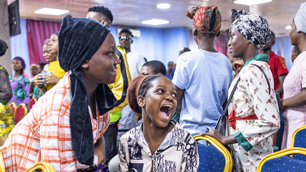 Friends laugh at a church in Lagos, Kenya - March 2023