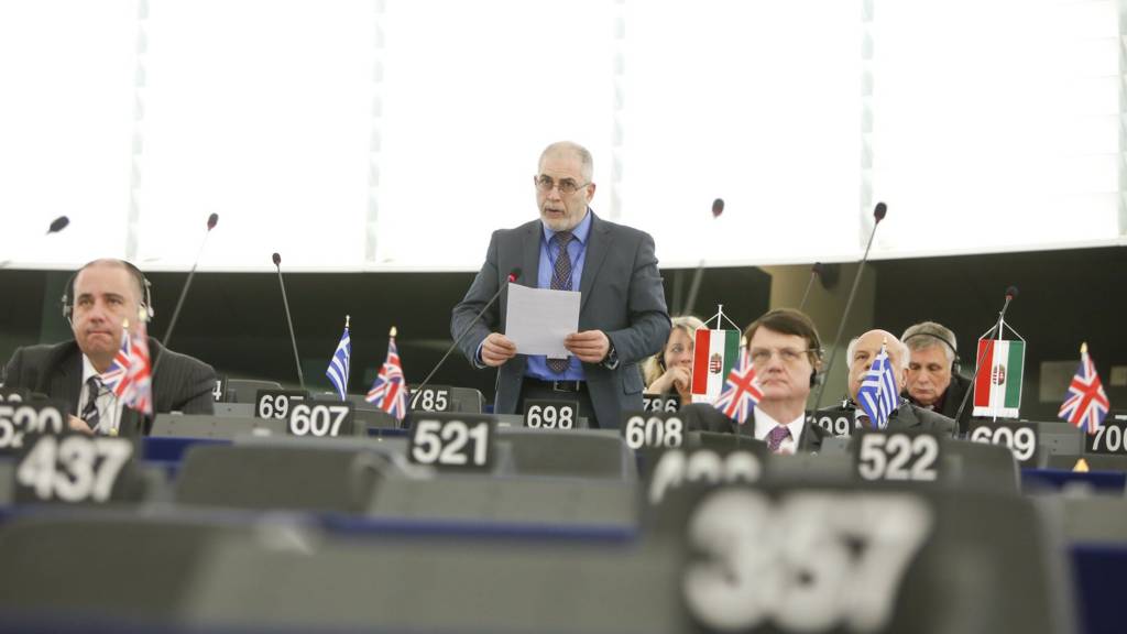 Flags on desks in the European Parliament