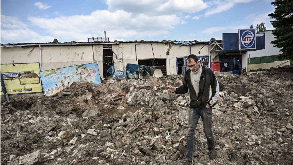 A man walks in front of a destroyed super market after a strike in the city of Soledar at the eastern Ukranian region of Donbas on 24 May 2022, on the 90th day of the Russian invasion of Ukraine.