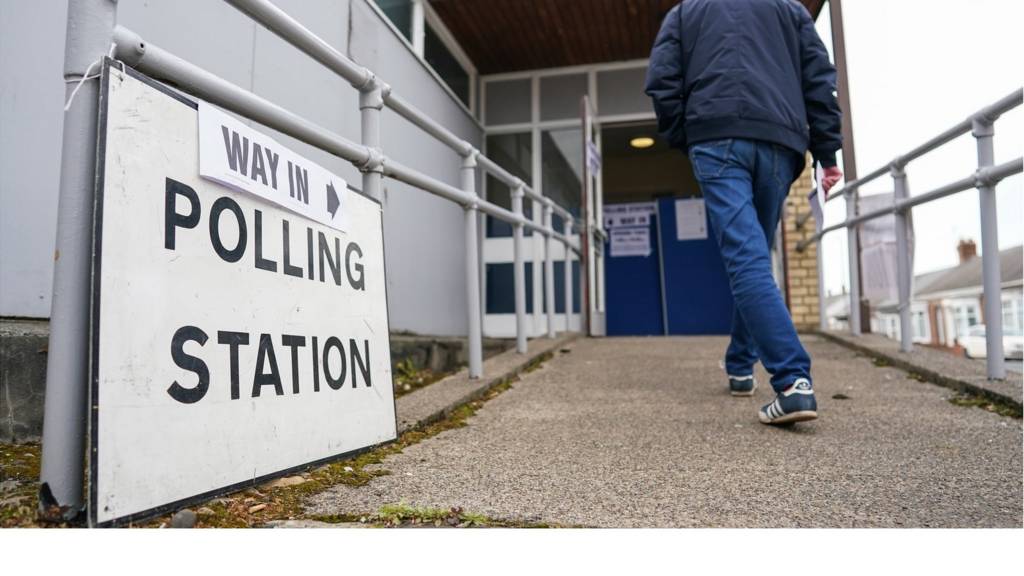 man walks into a polling station