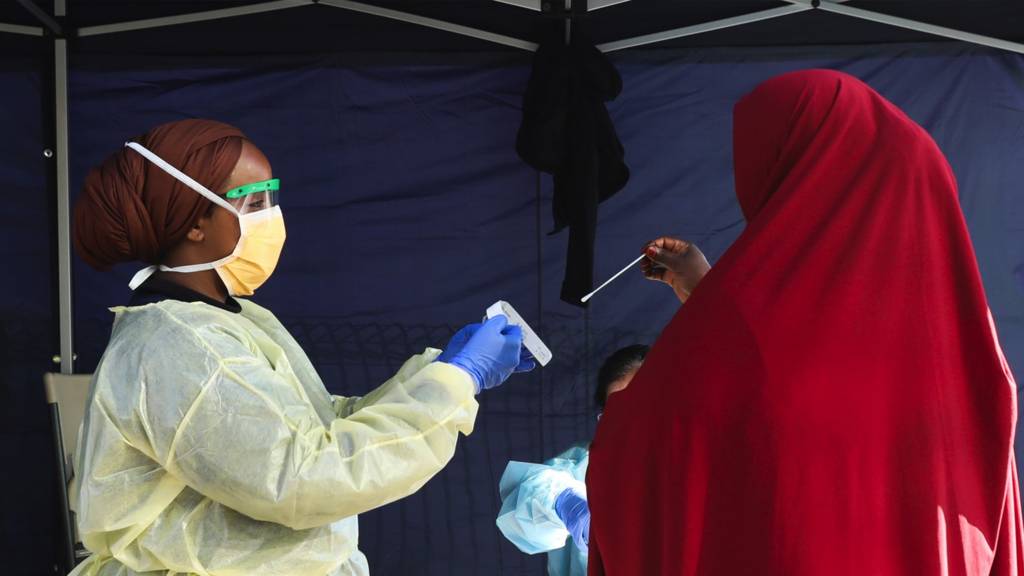 A woman places her swab into a medical testing bag at a pop-up testing site during a COVID-19 testing blitz in the suburb of Broadmeadows on June 28, 2020 in Melbourne, Australia