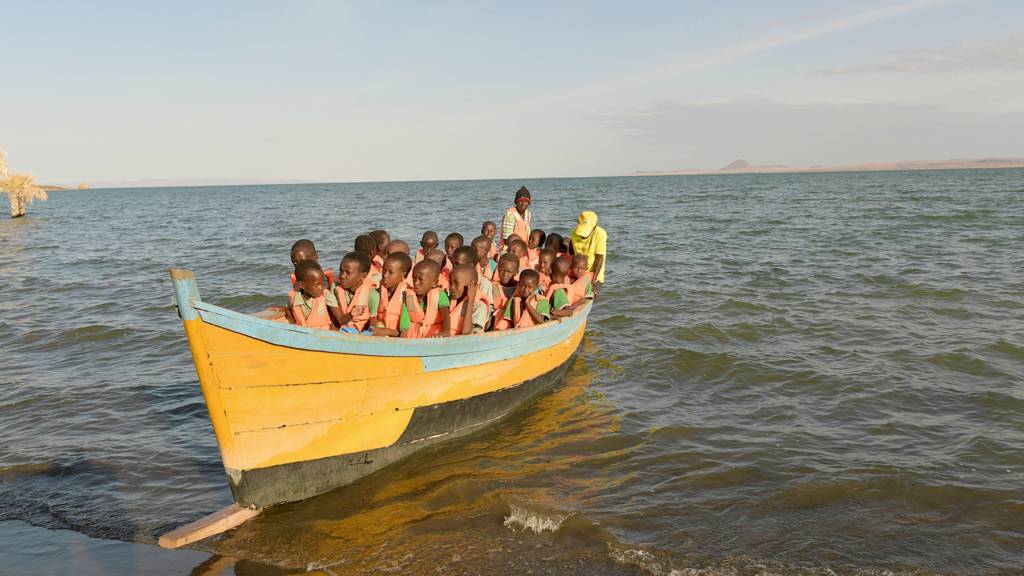 Children in northern Kenya take a boat to school as Lake Turkana has made it impossible for them to go by land - July 2022