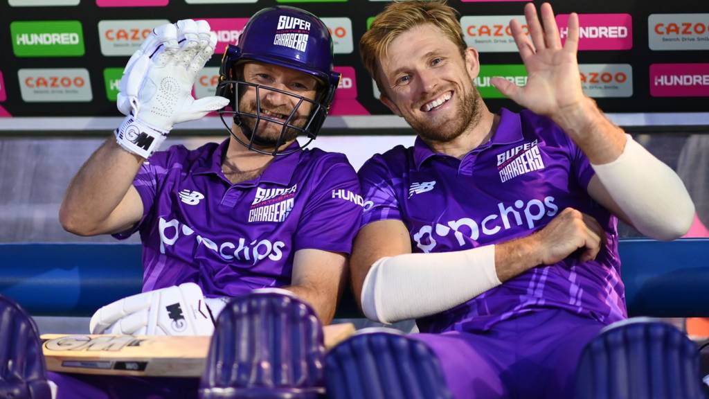 Northern Superchargers players Adam Lyth (left) and David Willey (right) wave while sat in the dugout