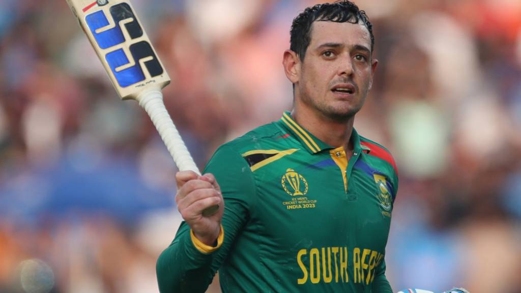 South Africa opener Quinton de Kock raises hit bat as he walks off after being dismissed for a century