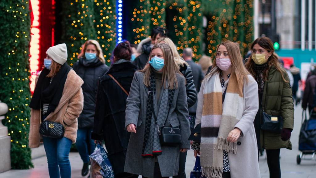 Shoppers, some wearing face masks, on Oxford Street in central London. Picture date: Monday December 6, 2021.