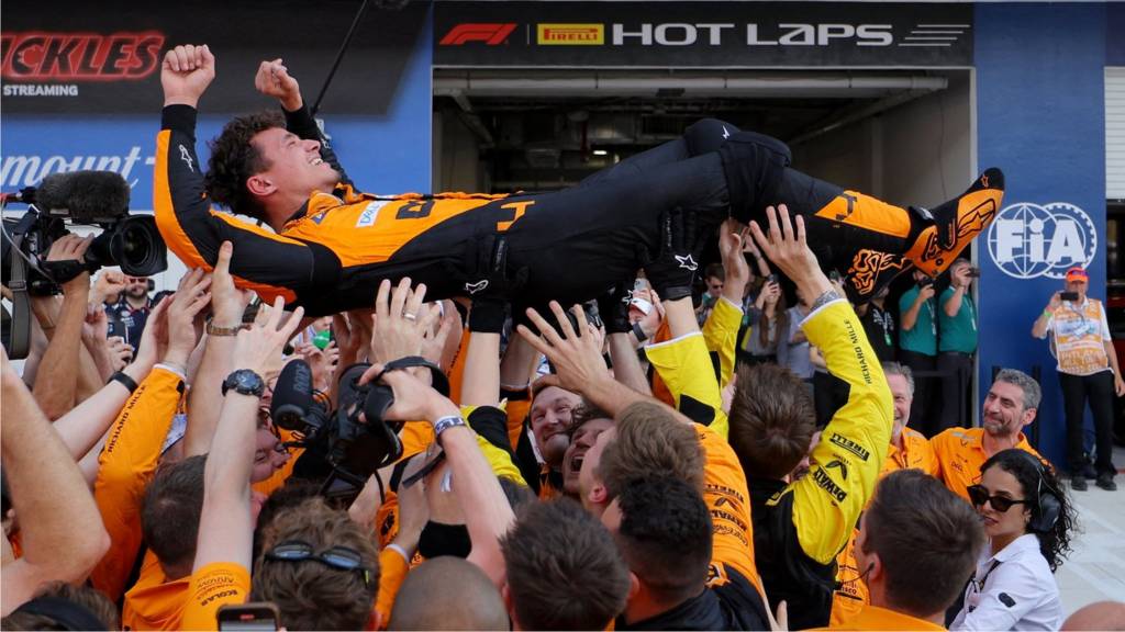 Lando Norris 'crowd-surfs' in celebration with McLaren mechanics after winning the Miami Grand Prix