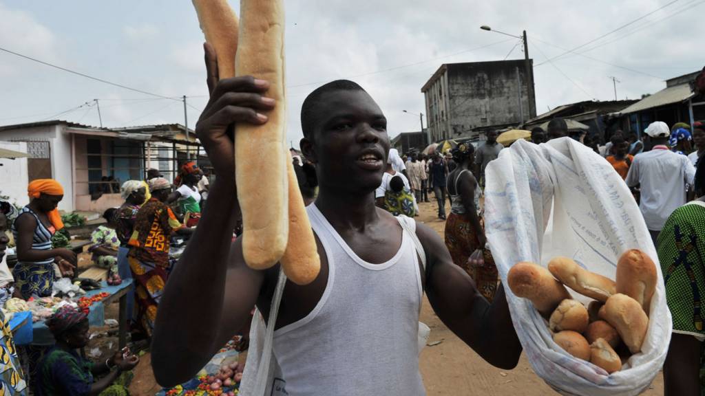 Man selling bread in Ivory Coast