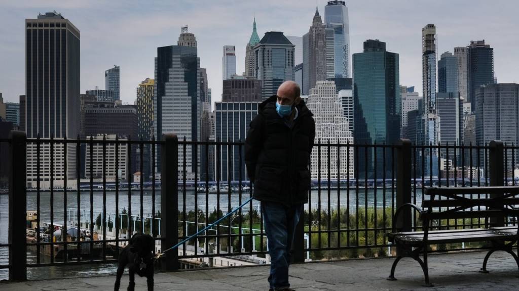 Man walks dog along promenade in Brooklyn, New York City - 23 April