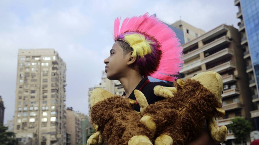 Egyptian boy in pink wig