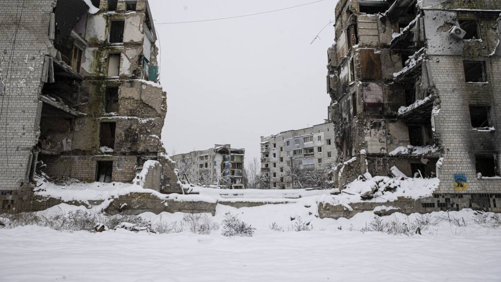 A snowy scene amid damaged buildings in Borodyanka, Ukraine