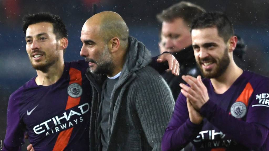Pep Guardiola and David Silva walk off after Manchester City's quarter-final win at Swansea