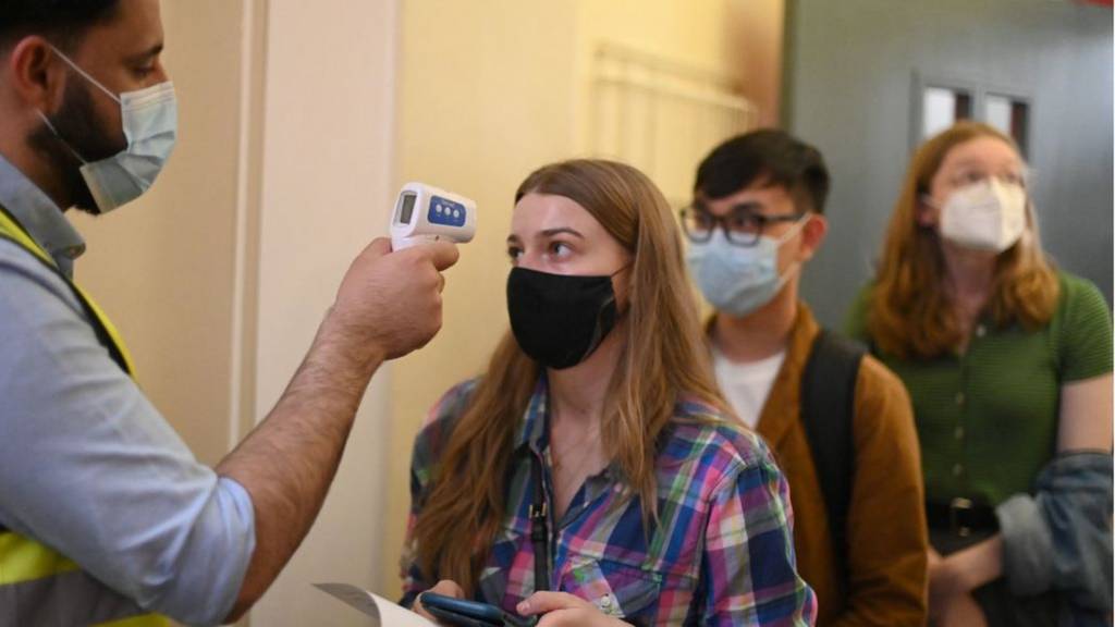 Students queue for vaccination in London
