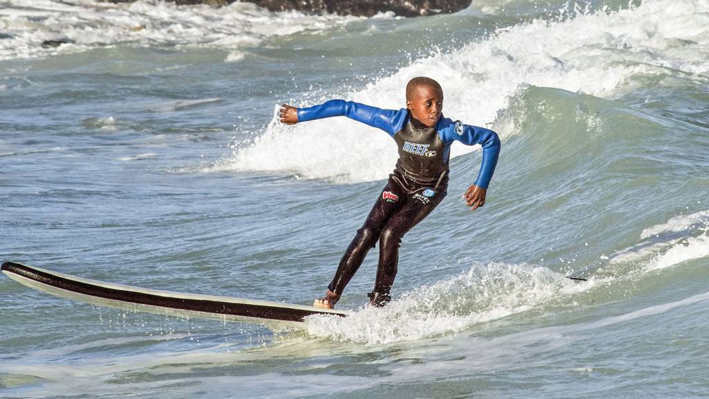 A boy surfing in Cape Town, South Africa