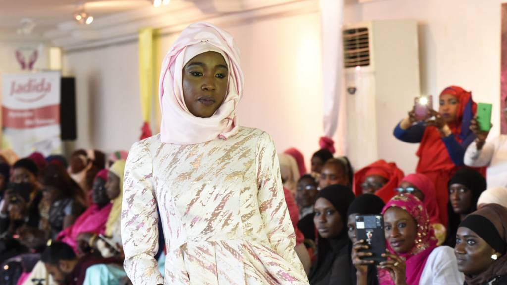 A model presents a hijab and a dress on 30 January 2016 during the Muslim Woman show in Dakar, on the eve of World Hijab Day