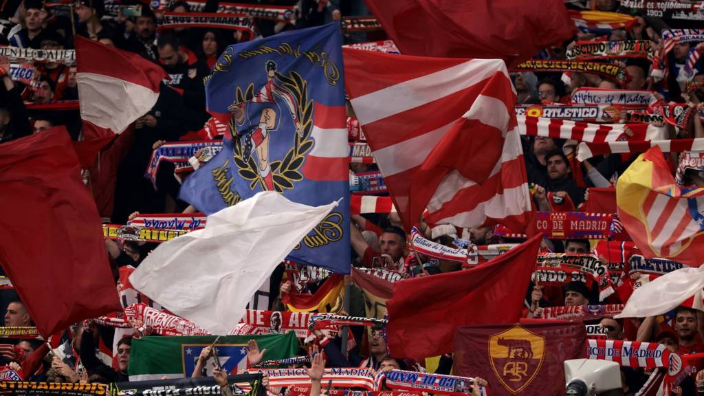 Atletico de Madrid fans wave giant flags and cheer on their team at the Civitas Metropolitano Stadium