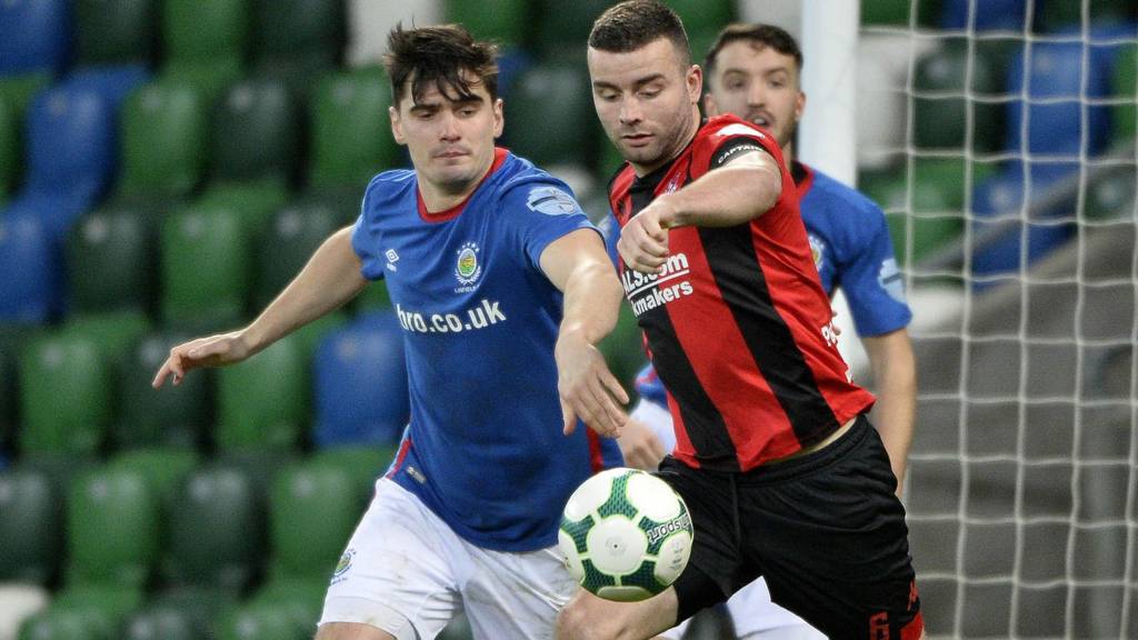 Linfield's Jimmy Callacher in action against Colin Coates of Crusaders