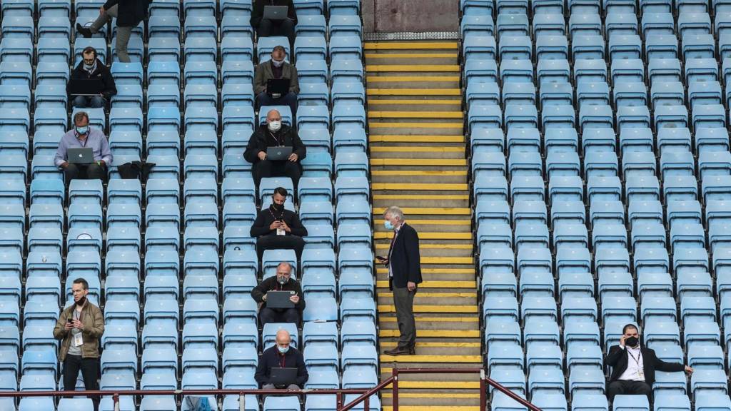 Journalists sit in the stands observing social distancing prior to the English Premier League football match between Aston Villa and Sheffield United at Villa Park in Birmingham, England on 17 June 2020.