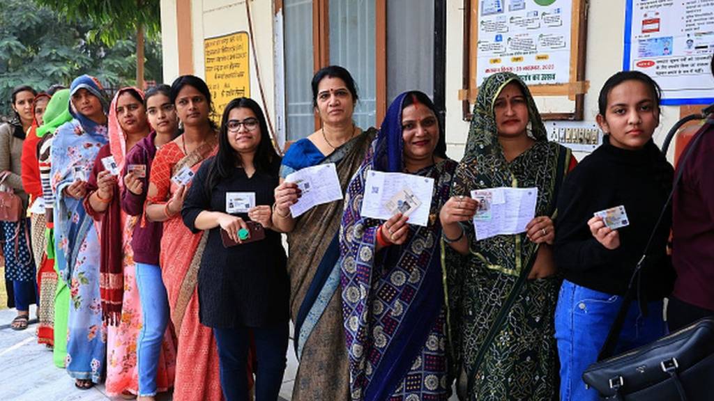 Women stand in line to vote for the Rajasthan Assembly elections in Jaipur on November 25, 2023