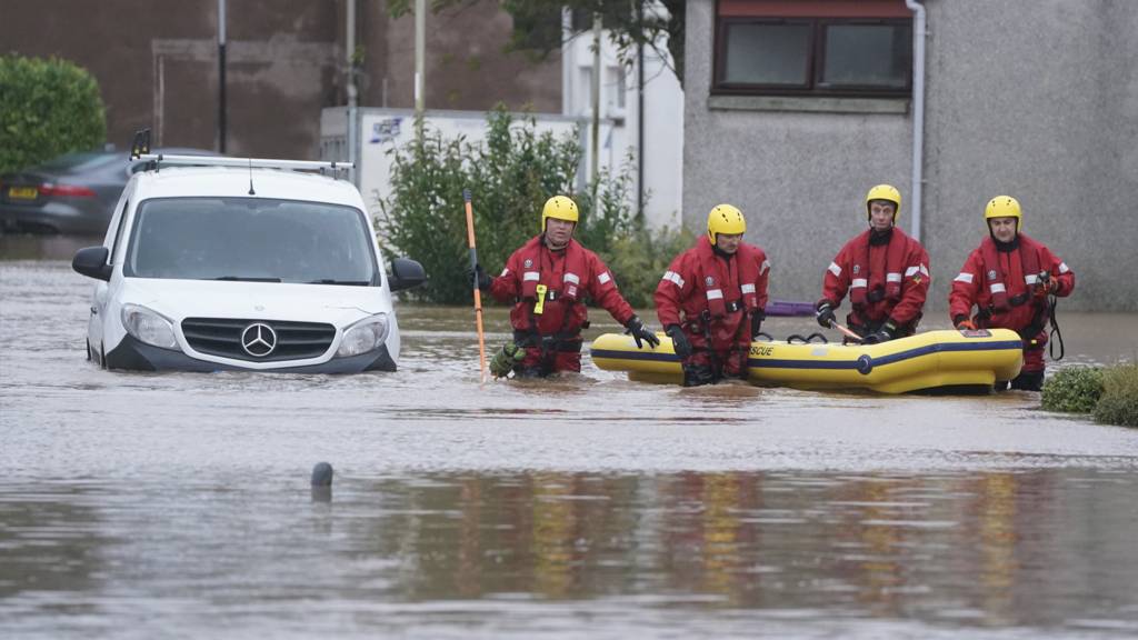 Members of the emergency services in Brechin, Scotland, as Storm Babet batters the country