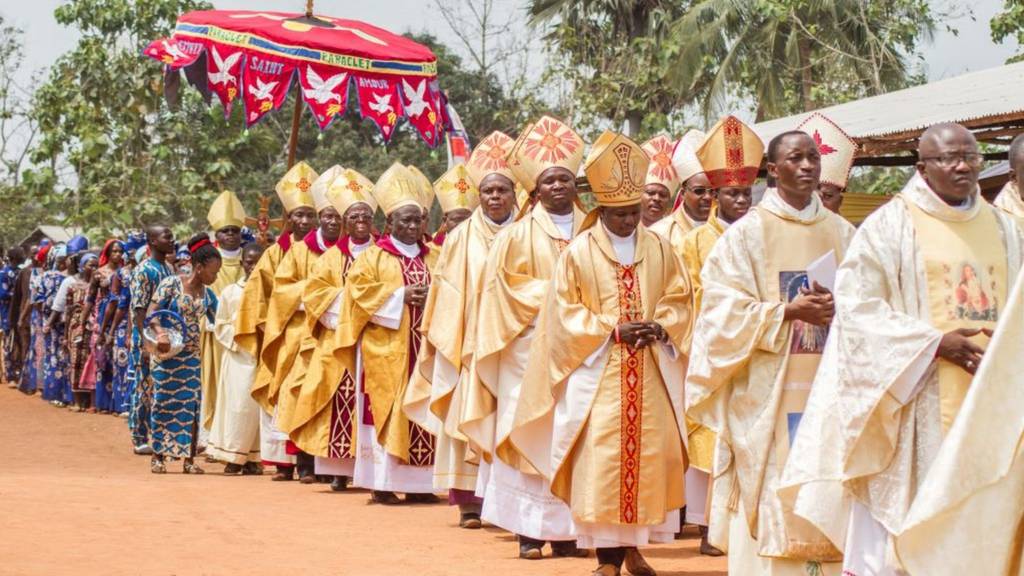 Priests of the Very Holy Church of Jesus Christ of Baname arrive at the Nazareth church in Djidja, Benin on February 25, 2017 at the beginning of a service