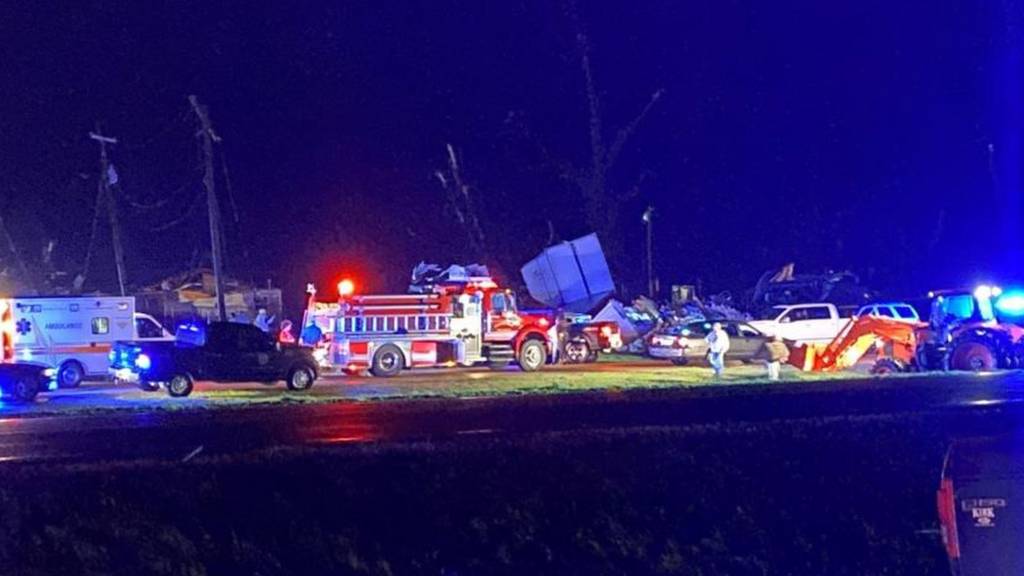A handout photo showing destruction and emergency services at the scene after tornadoes tore through the US state of Mississippi