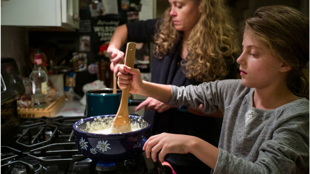 Family cooks on stovetop.