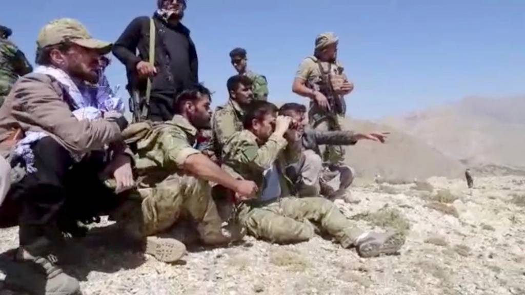 Members of National Resistance Front observe from a hill in Panjshir Valley, Afghanistan in this undated handout picture