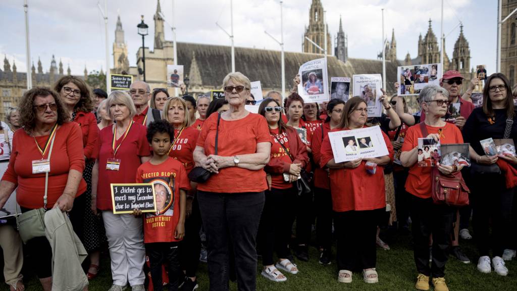 People affected by the infected blood scandal attend a vigil in Parliament Square on May 19, 2024 in London, England
