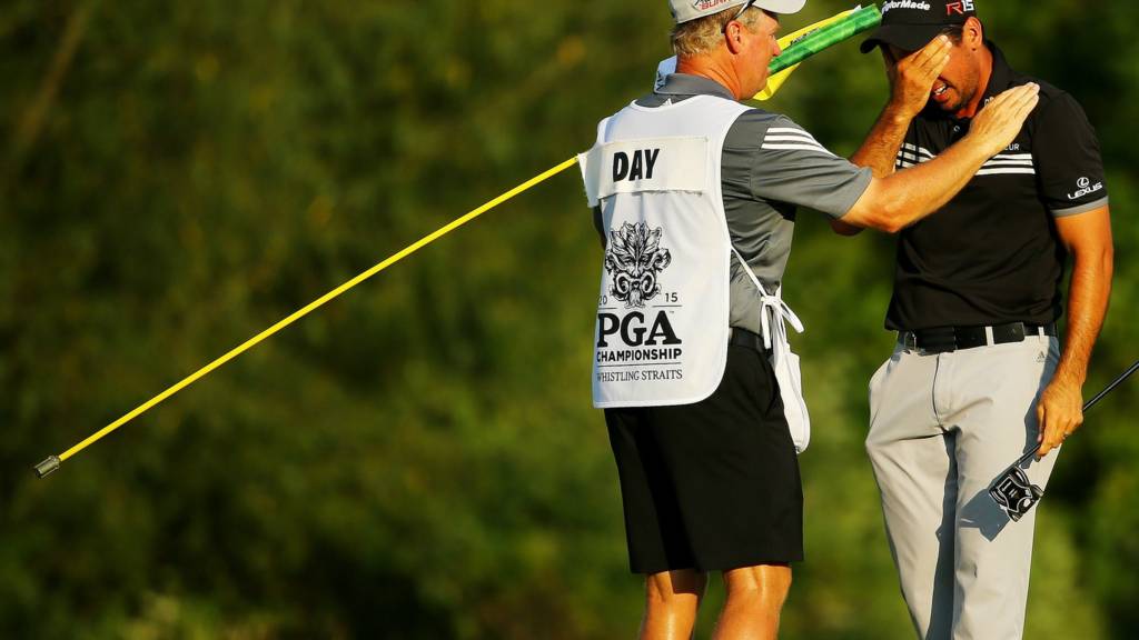 Jason Day with his caddie after winning his first major