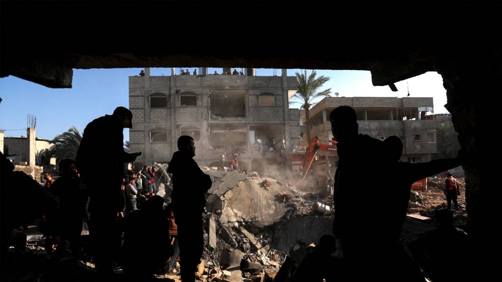 Palestinians search for casualties at the site of an Israeli strike on a house, amid the ongoing conflict between Israel and the Palestinian Islamist group Hamas, in Rafah, in the southern Gaza Strip, December 19, 2023