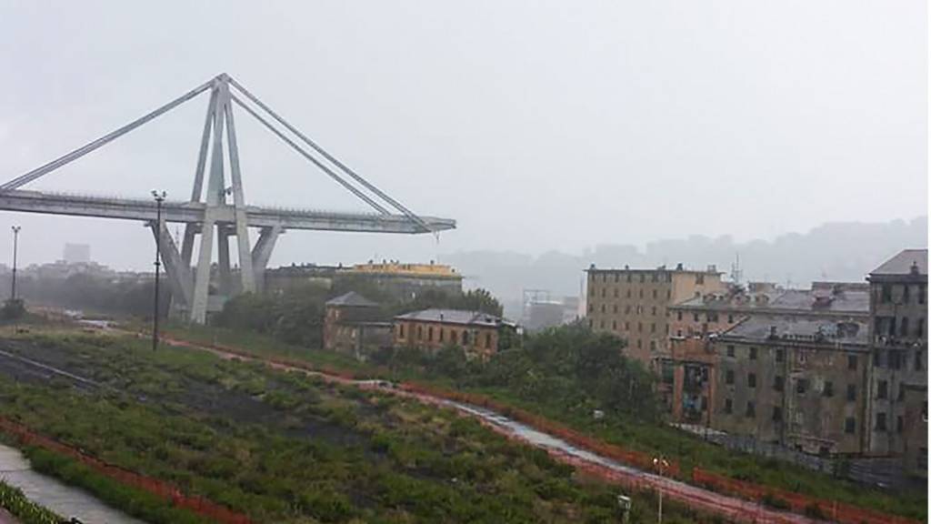 The collapsed bridge is seen over the city