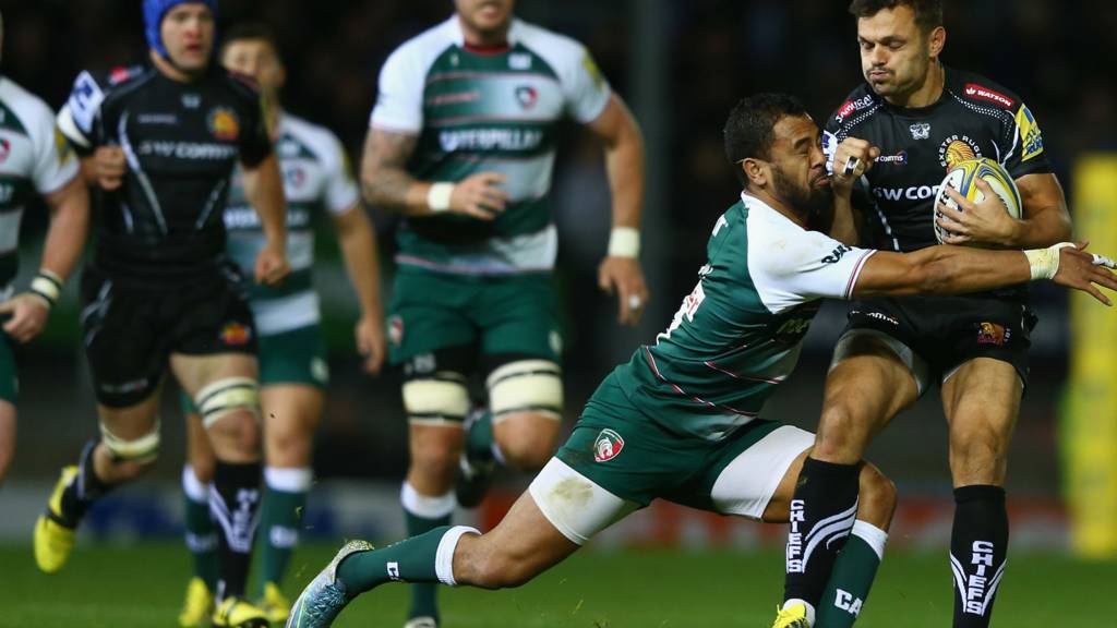 Phil Dollman (R) of Exeter Chiefs is tackled by Telusa Veainu of Leicester Tigers