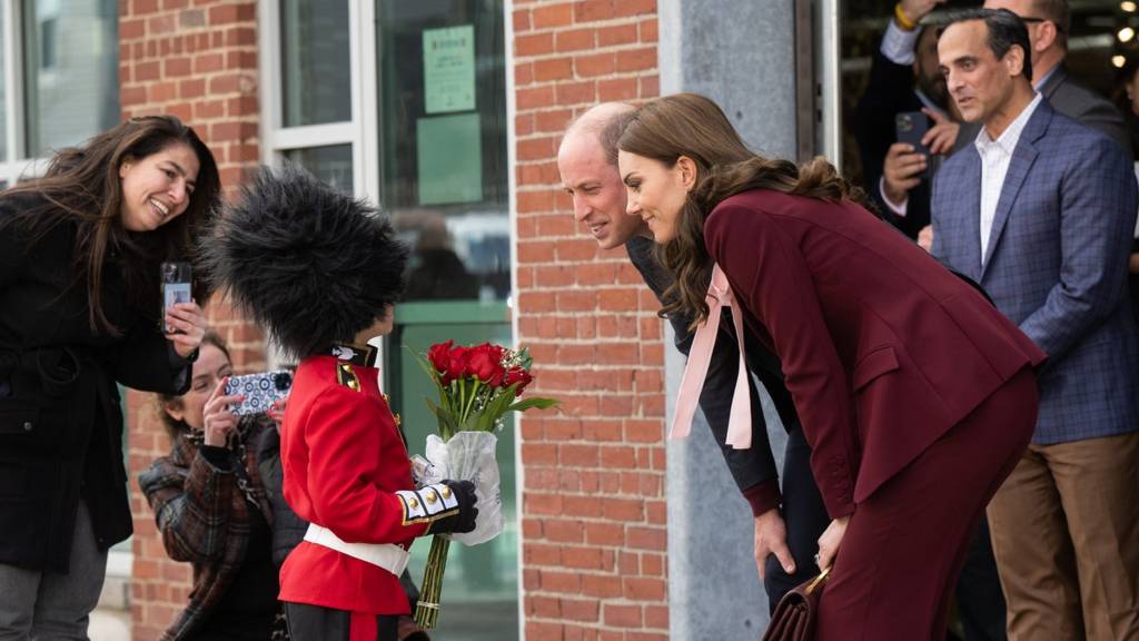 William and Kate, the Prince And Princess of Wales, meet a boy dressed as a guard in Boston