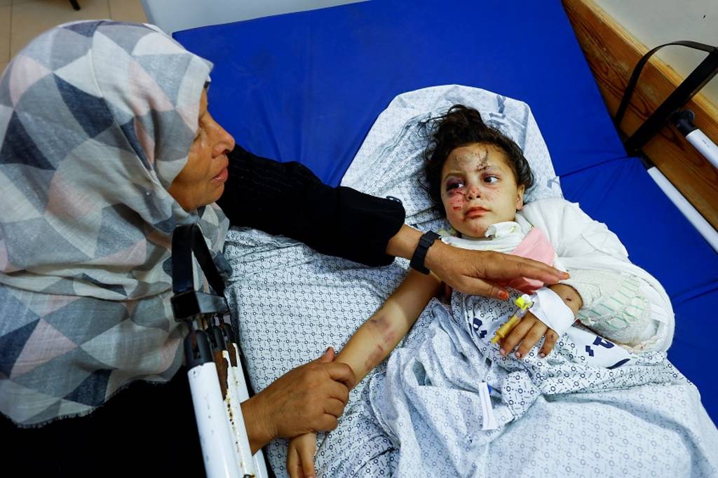 An injured child with her grandmother in a hospital in Gaza