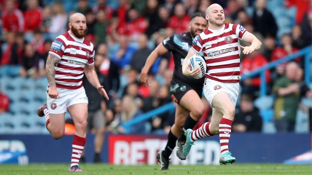 Wigan Warriors makes a break before scoring their side's fourth try during the Betfred Challenge Cup Semi Final match