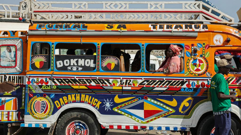 A woman sits in a bus on the outskirts of Dakar, Senegal - March 2024